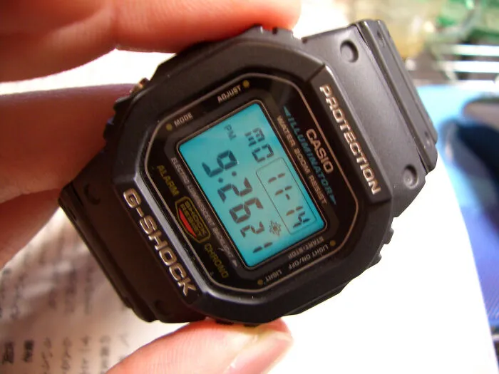 Person holding Casio G-Shock watch