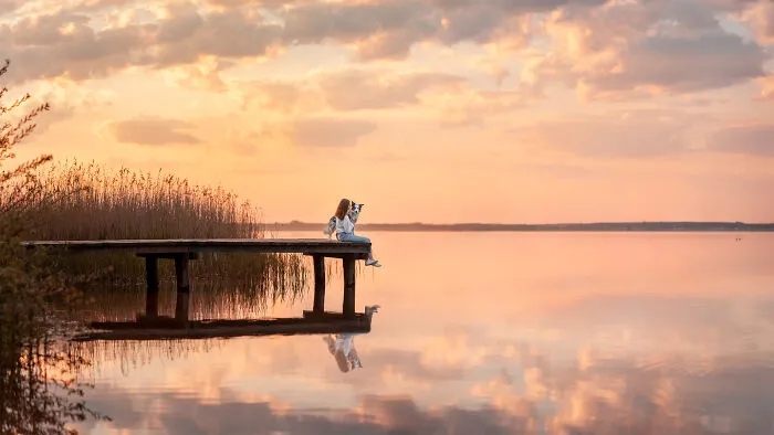 Human and the dog by the lake
