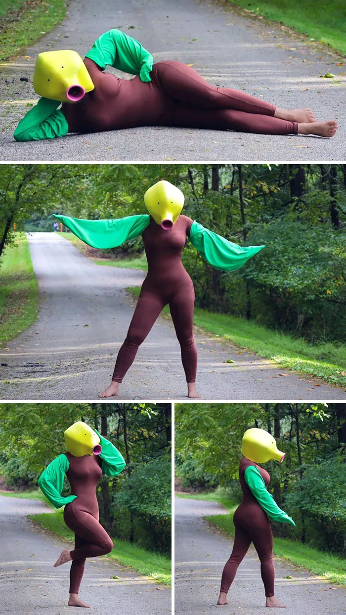 Person wearing clever Halloween costume with green sleeves and yellow duckbill mask posing outdoors on a road.