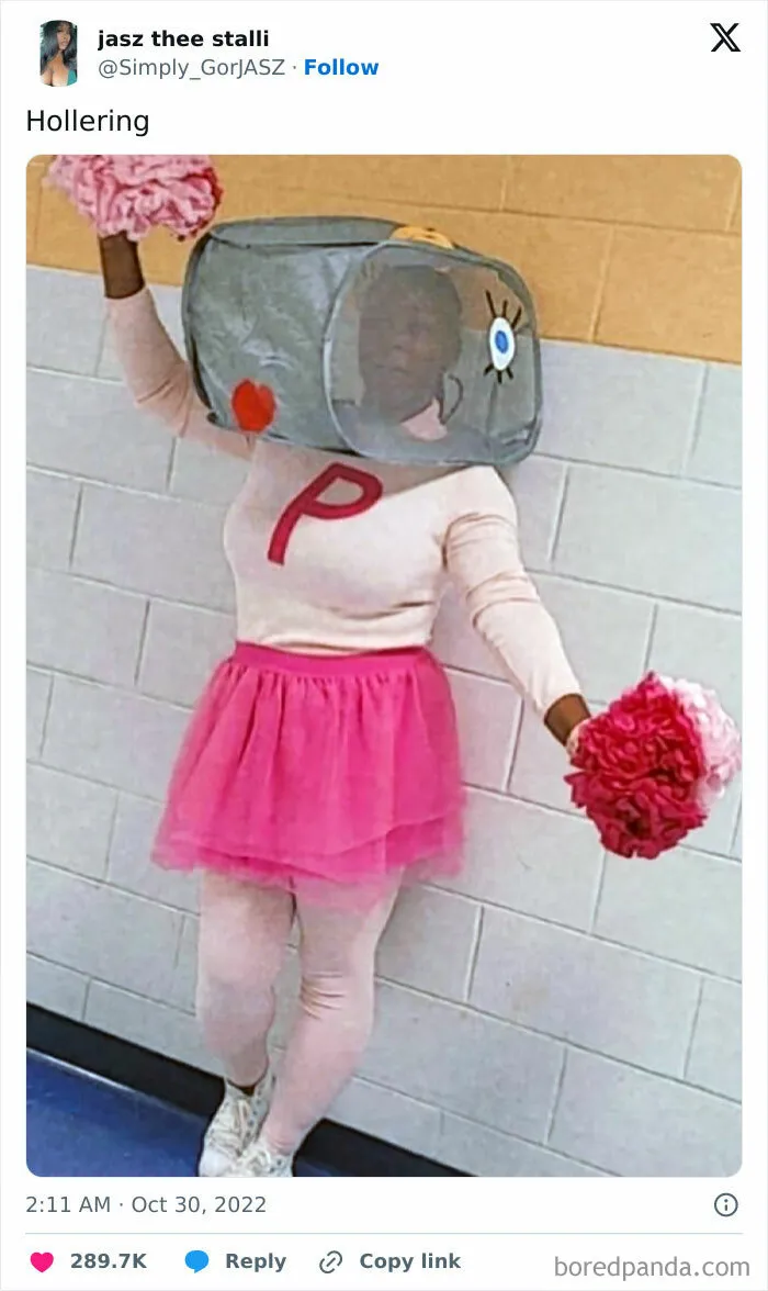 Person wearing a clever Halloween costume with a pink tutu and a large cartoon-style headpiece holding pom-poms.
