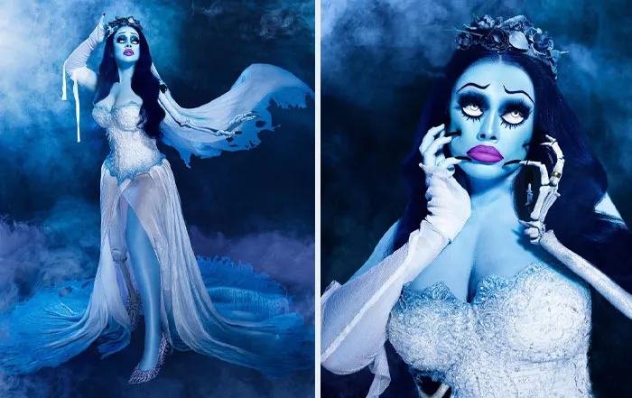 Woman in a clever Halloween costume with blue skin, skeletal hand, and flowing white dress in a smoky setting