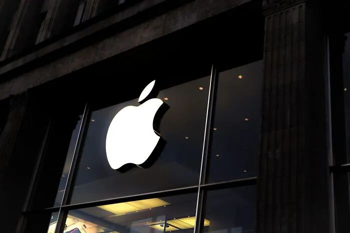 Bright Apple logo on a storefront, reflecting shower thoughts and innovation.