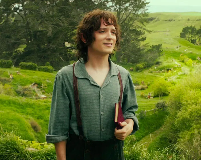 A character standing in a lush, green landscape, holding a book, possibly pondering shower thoughts questions.
