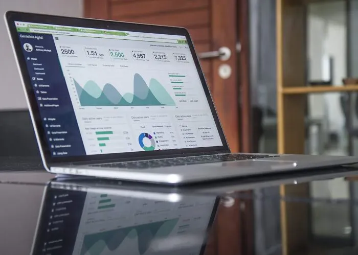 Laptop displaying analytics on a desk, reflecting data trends and insights, related to shower thoughts questions.