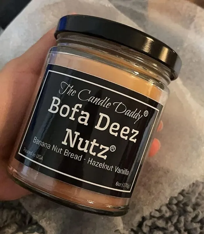 Create A Glowing Atmosphere Of Fun With The <a Style="Display:inline;" Href="Https://Www.amazon.com/Funny-Hazelnut-Vanilla-Scented-Candle/Dp/B07kfr7q67?crid=vvj1v94y0d47&keywords=funny+gifts&qid=1700736832&sprefix=funny+gifts%2caps%2c285&sr=8-104&linkcode=ll1&tag=bporangutan-20&linkid=e7b0ba8caa67a478949a9904627301f4&language=en_us&ref_=as_li_ss_tl" Target="_blank"><span Style="Font:inherit;color:#d74b1f;"> Bofa Deez Nutz Scented Candle</Span> - Because Who Said Home Scents Can't Be A Little Nutty?