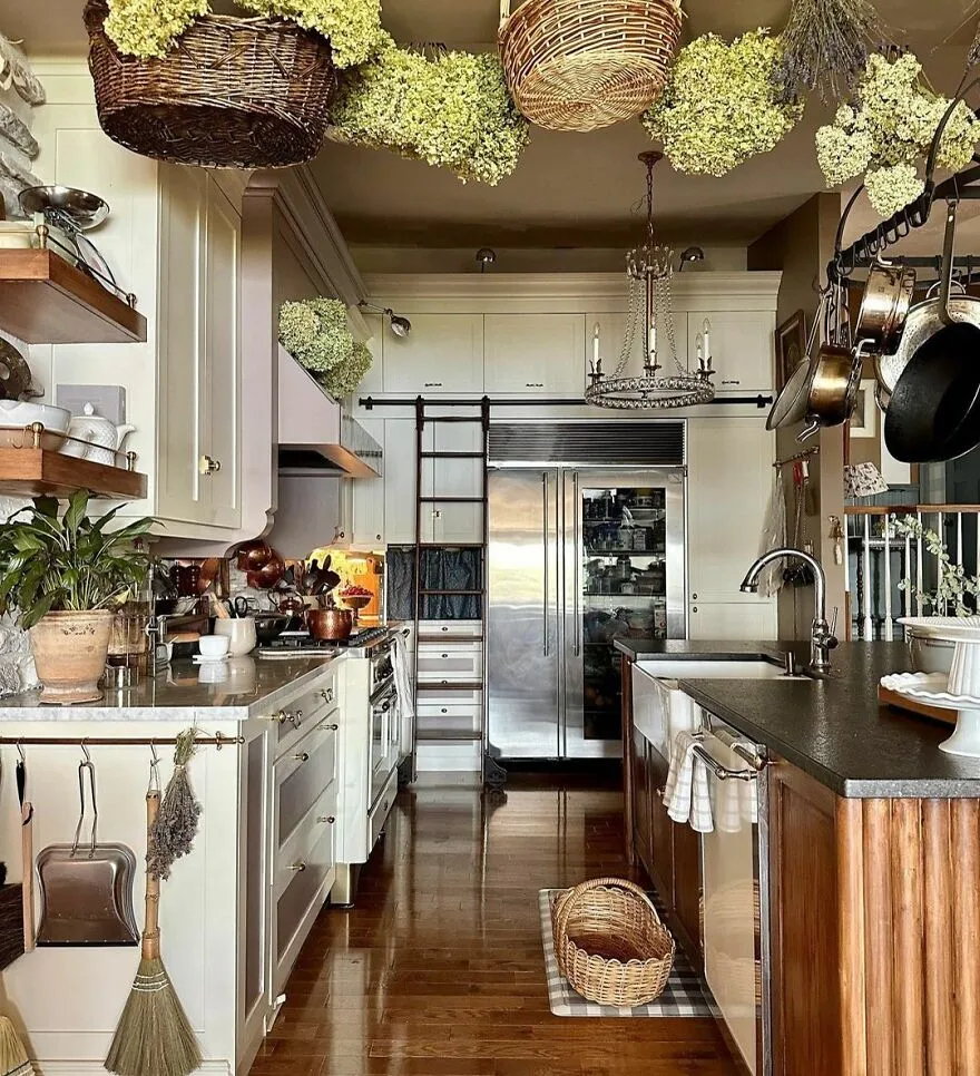 French country kitchen with modern and stylish kitchen cabinets, featuring wooden floors and hanging baskets.