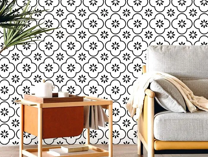 Room with Moroccan patterned wallpaper gray sofa and table