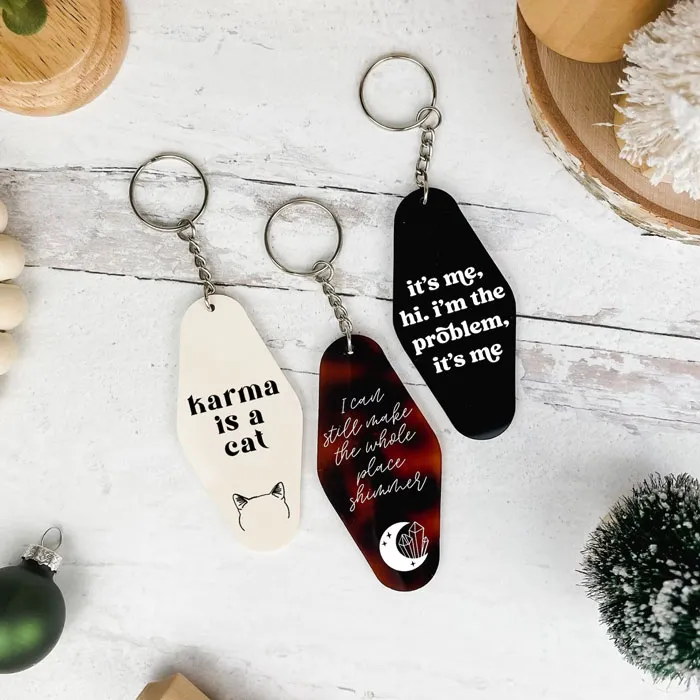Taylor Swift Midnights Keychain: Add some class to their set of keys with this engraved and hand-painted acrylic keychain inspired by Taylor Swift's Midnights album.