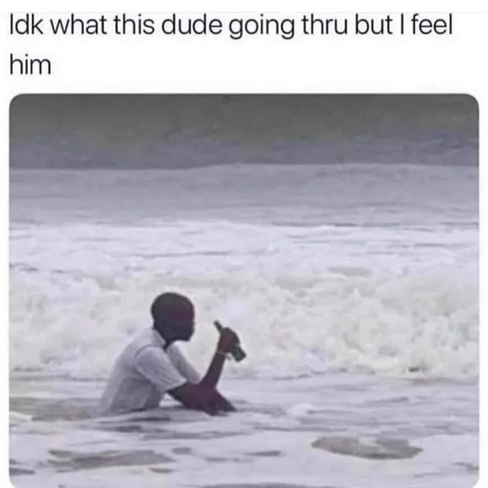 A man in ocean waves giving a thumbs-up, expressing a relatable awkward moment.