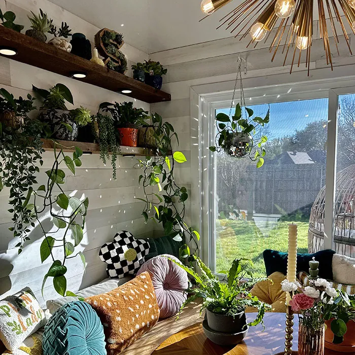 Breakfast nook with shelves full of greenery showcasing easy and creative wall art ideas for a stylish space.