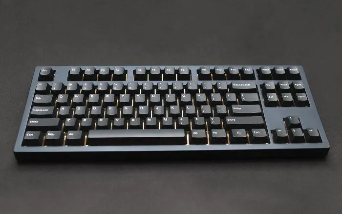 Black computer keyboard on dark table, related to solving hard riddles with keen wits.