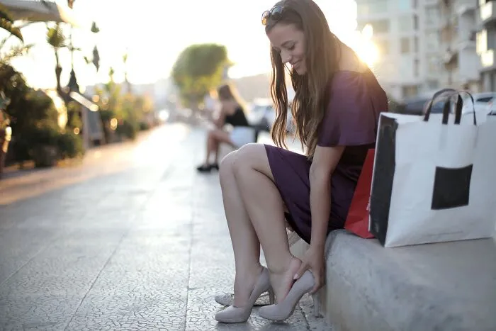 Woman adjusting her high heels 