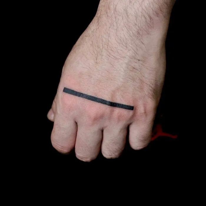 Minimalist black line tattoo on a hand, showcasing small hand tattoo design.