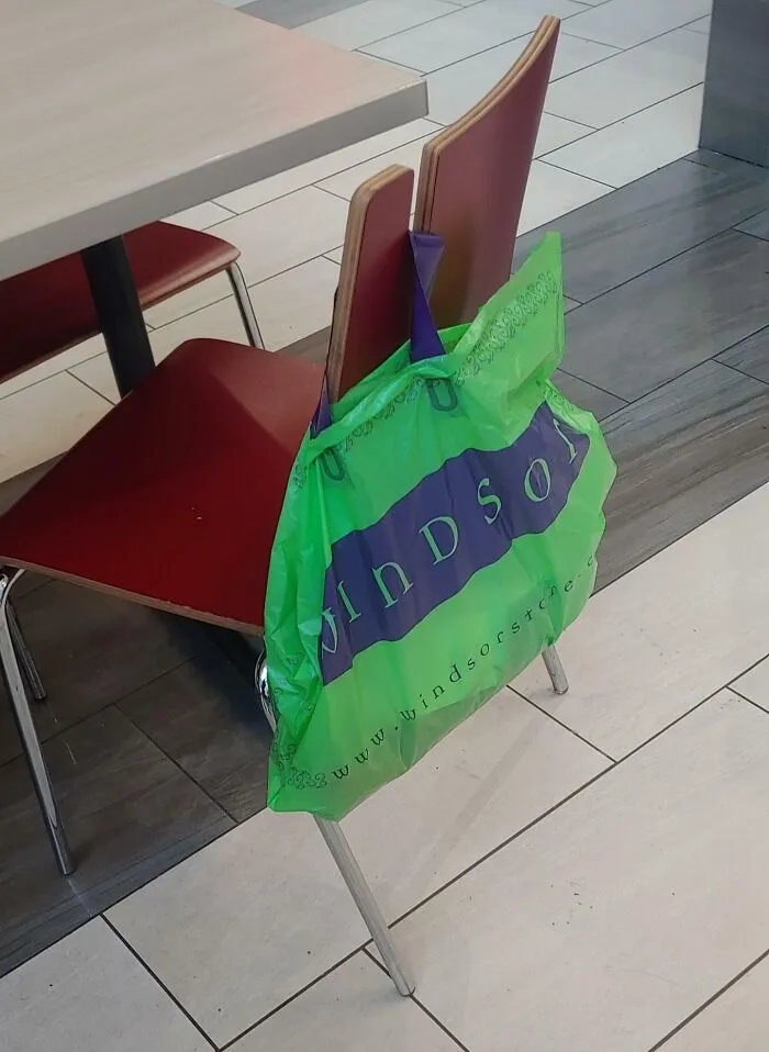 This Chair In The Food Court Of A Mall Has A Notch Cut Out For Your Bags