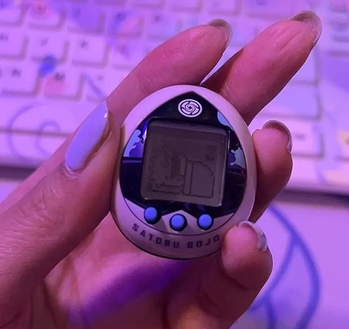 You 'Gojo' Have A Lot Of Fun With The Tamagotchi Nano X Jujutsu Kaisen - Satoru Gojo (Japanese Version)! A Delightful 'Mash-Up' Of Classic Nostalgia And Anime Glow-Up!
