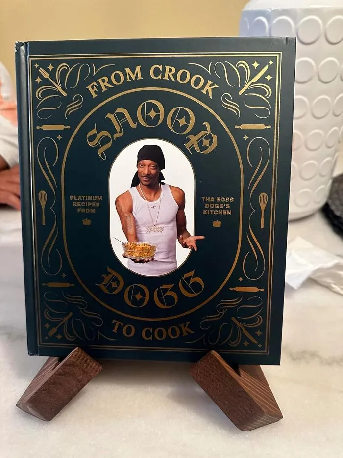 Funny product: Cookbook with humorous title by a popular figure, displayed on a stand.