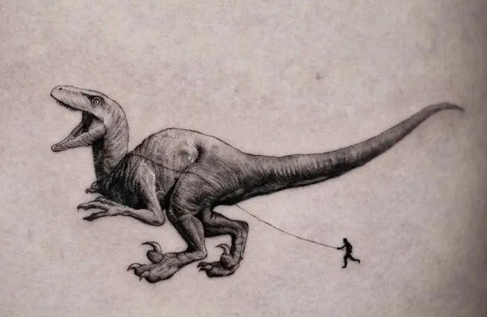 Dinosaur tattoo featuring a large dinosaur being led by a small figure, showcasing cool tattoo artistry.