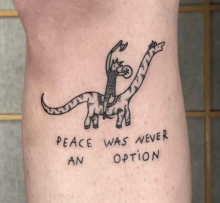 Cool dinosaur tattoo with a rider, featuring the text "Peace was never an option."