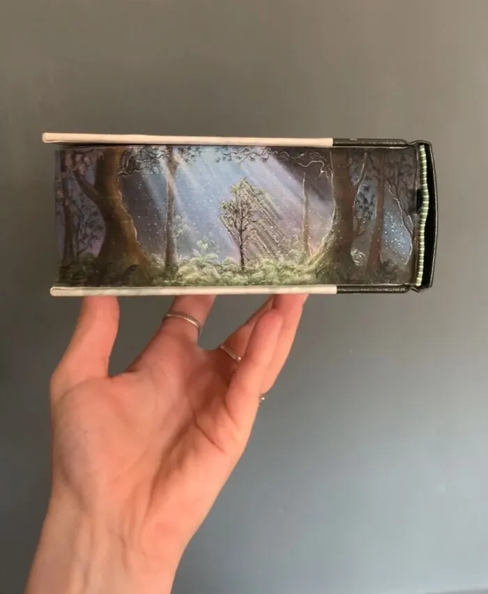 30 Magical Drawings On The Edges Of Popular Books Featuring Famous Scenes Done By This Artist
