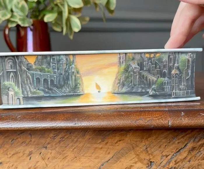 30 Magical Drawings On The Edges Of Popular Books Featuring Famous Scenes Done By This Artist