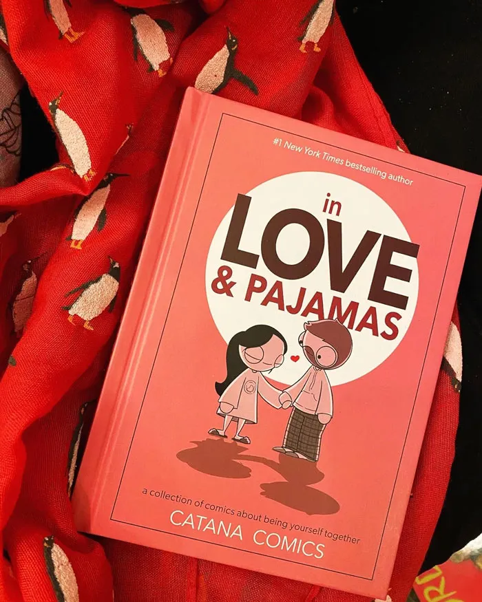 Valentine's Day gift idea: "In Love & Pajamas" comic book on a penguin-patterned red blanket.