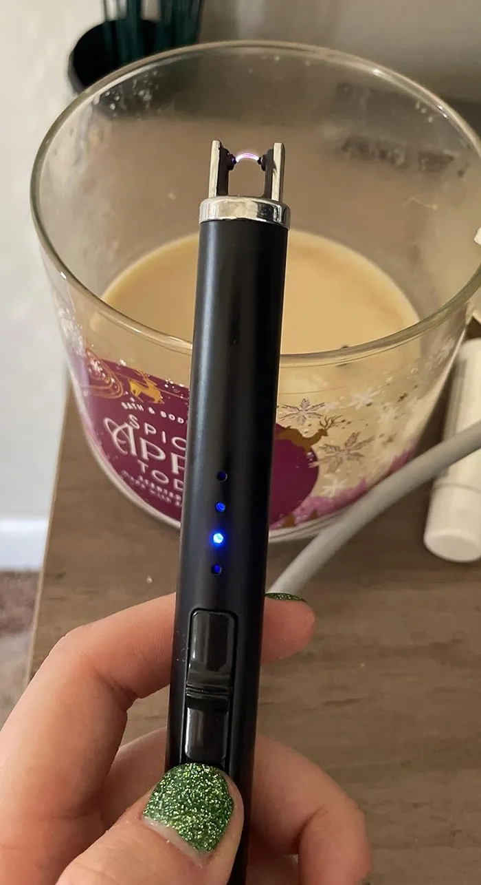 Hand holding an electric lighter with blue lights, perfect Valentine's Day gift under $25.