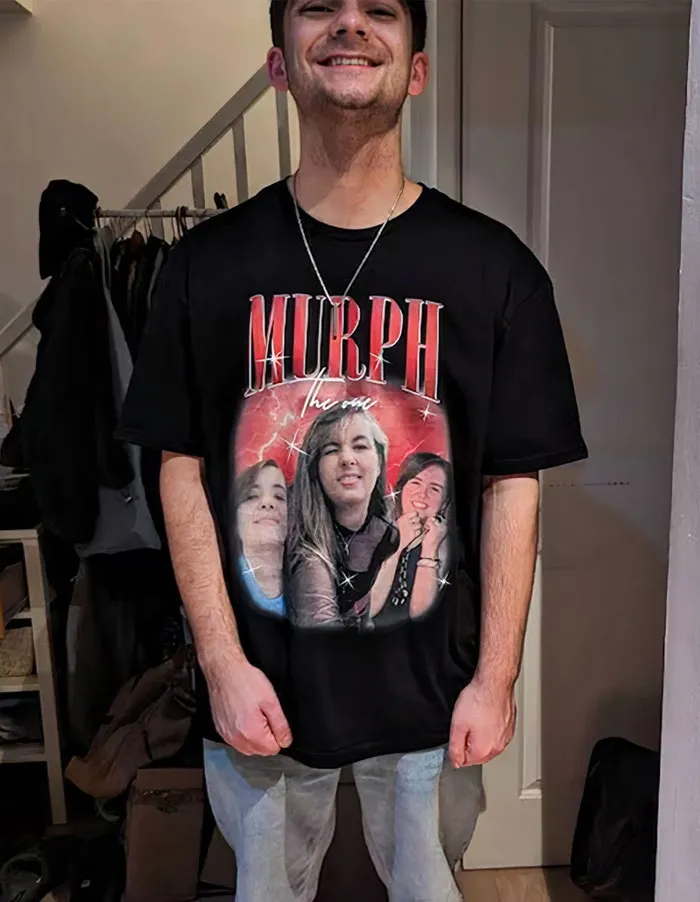 Smiling person wearing a black T-shirt featuring three women's faces, perfect for romantic Valentine's Day gifts.
