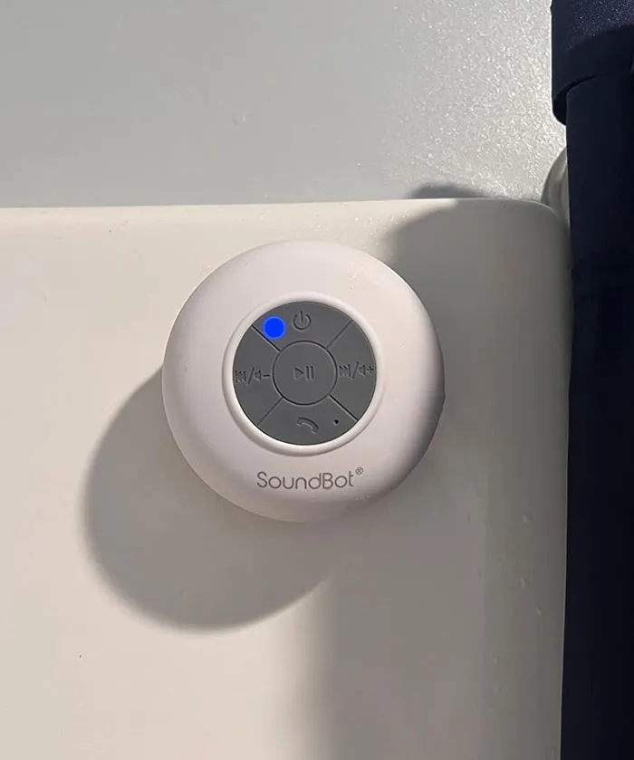 Bluetooth speaker under $25, ideal Valentine's Day gift, mounted on a white surface.
