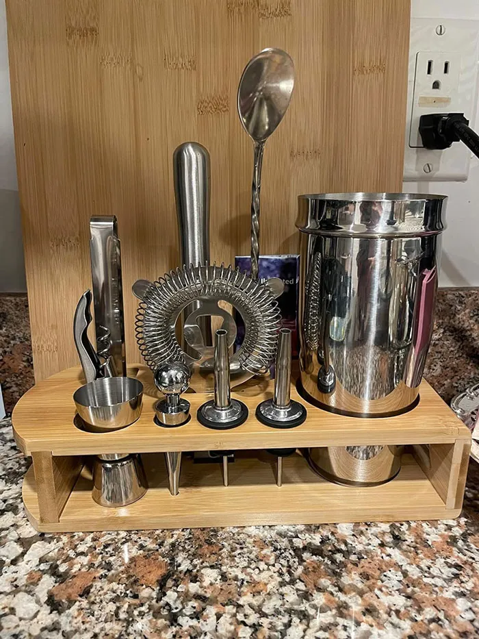 Bar tool set with stainless steel accessories on a wooden stand, ideal Valentine's gift under $25 for cocktail lovers.
