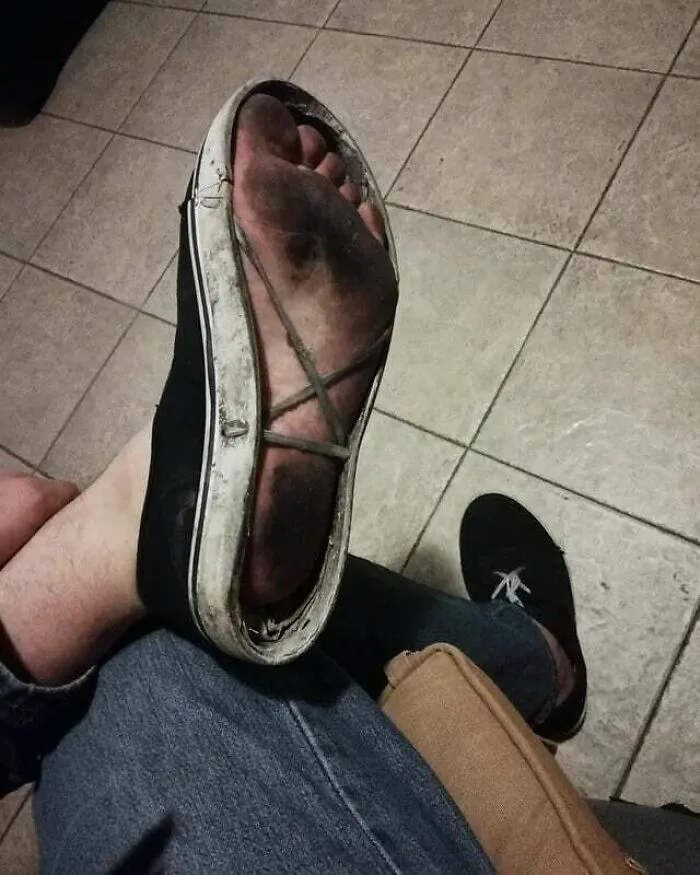 Cursed image of a worn-out shoe with foot visible inside, adding a weird touch to the unusual scene.