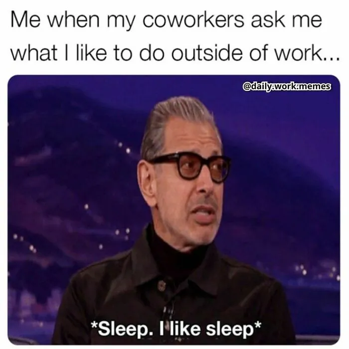 Man in glasses humorously responding to coworkers about hobbies outside work, stating he likes sleep.