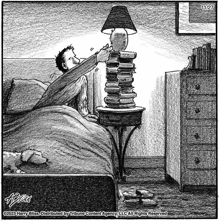 Clever one-panel comic by Harry Bliss illustrating a man in bed using a stack of books to reach a lamp.