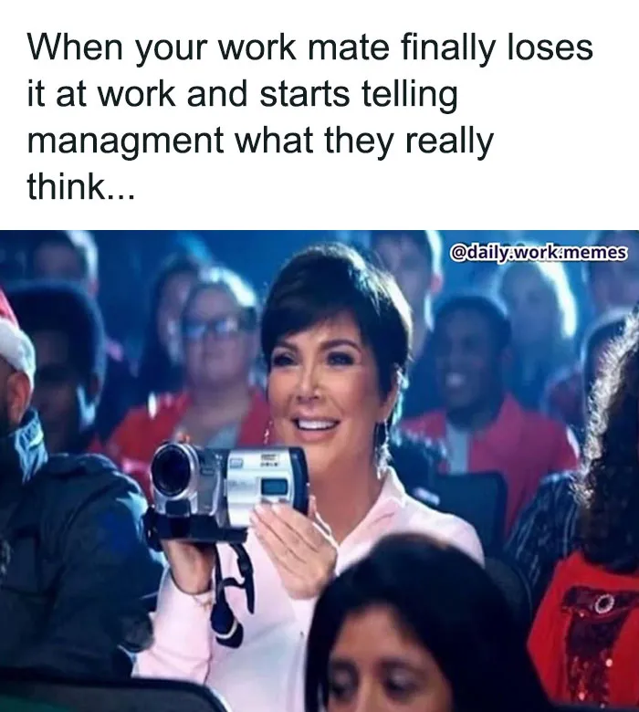 Person filming a funny and relatable work meme moment during a meeting, capturing a candid reaction.