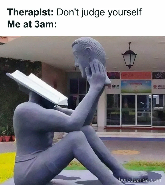 Statue with a book as its head and a human face held by hand, depicting introvert humor.