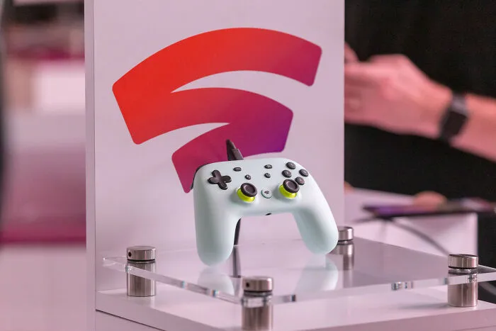 White gaming controller on display with a tech logo, symbolizing a product that failed despite being declared the next big thing.