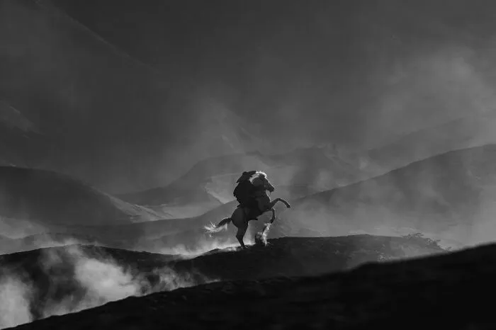 1st Place In The Landscapes Category: "Dust-Laden Hooves: Saga Of The Volcanic Riders" By Mahendra Bakle, India