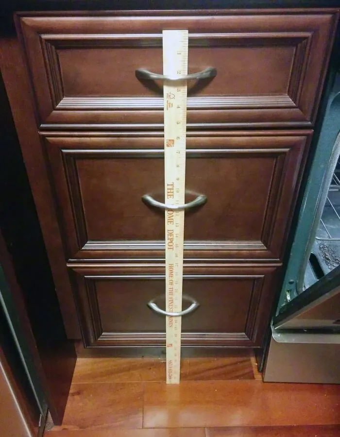 Keep Toddlers Out Of Kitchen Drawers By Inserting A Yardstick Into The Handles
