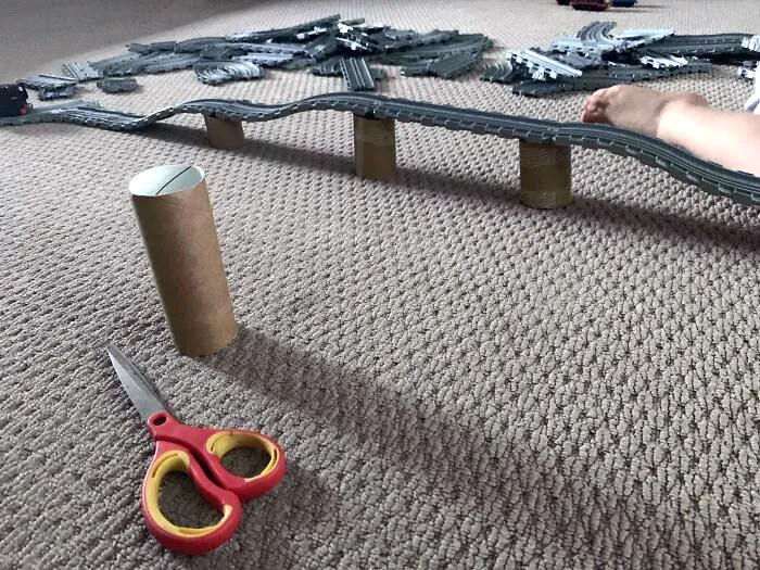 Cut Toilet Rolls Down And Use Them As Bridge Pillars For Your Kid's Train/Car Tracks