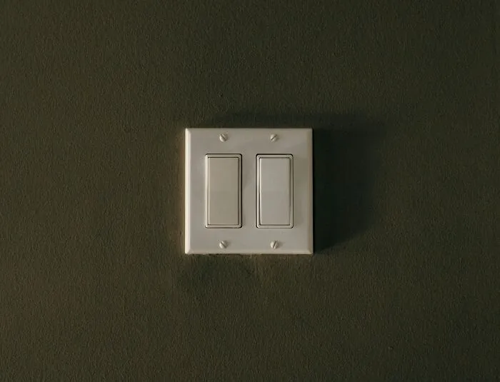 "Light switch on a dark green wall, illustrating advice that seemed like a joke at first."