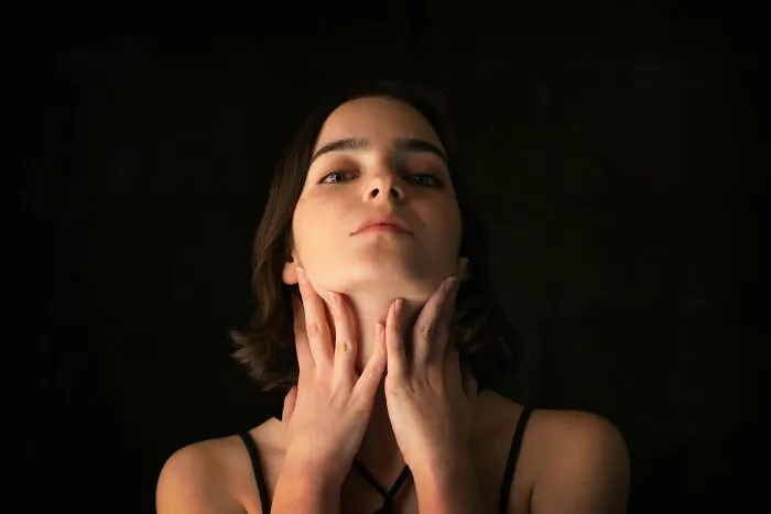 Woman holding her throat