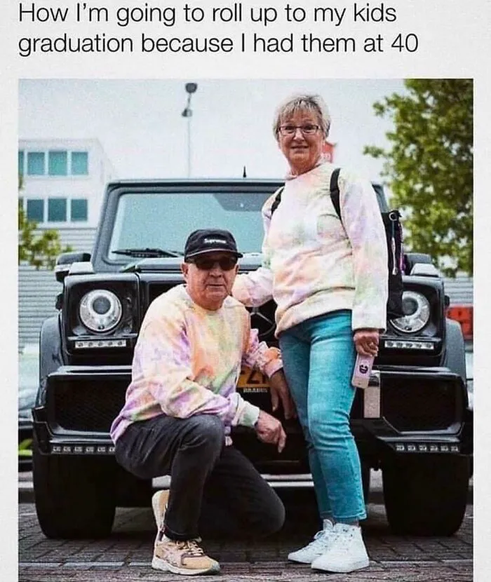Two adults in colorful sweatshirts posing humorously in front of a car, showcasing funny and goofy dad moments.
