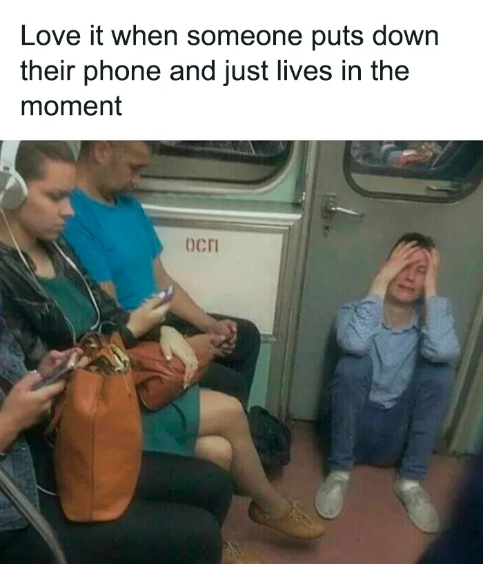 People on a subway using phones while one person sits on the floor holding their head, illustrating a mental health meme.