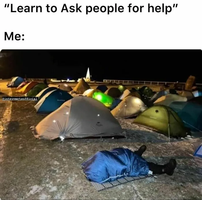 Campground at night with tents and one person lying outside a sleeping bag, illustrating relatable introvert humor meme.