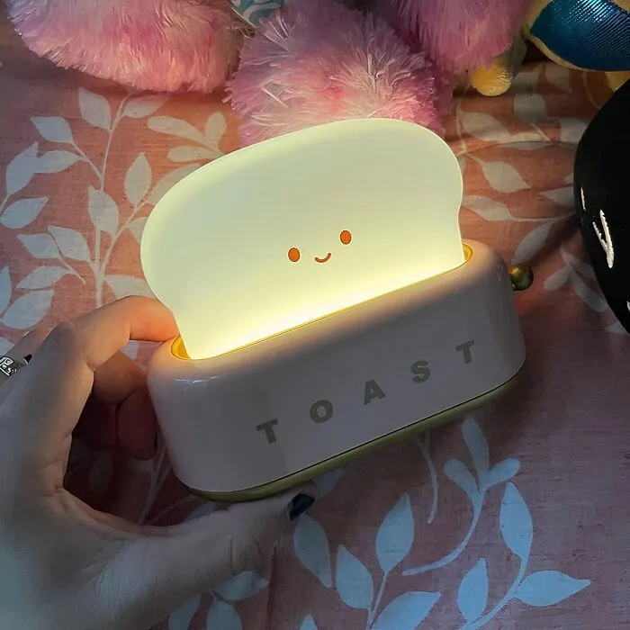 <a style="display:inline;" href="https://www.amazon.com/QANYI-Toaster-Rechargeable-Bedroom-Decorations/dp/B0B24ZYK97?crid=2HH05EAG38HQD&dib=eyJ2IjoiMSJ9.hVmLYgaAxqEFChH_X4htIDSwJmFPkdxb88NaCNrkhrcb8-qbUj1sNQ3qVqhZJHclO7v2215E9JMzu_Xn3-WQqcwoh3UYS8SyNAJh4DsvfehSiWf08HHrddyrZB2gmngwXjeReXO1xANvxUa06Sdku-OUpbbGs7VG5LP-yVXbvmWZboLFJsagC-fkVCbrzUWuku7DLi85IJtROmVjtK8cRhdf3g46Z7SR_z9VRGsg56X-B3u1J8NSduZG45DqX2Y2eEWYs3vl2H2dmVsCTmicDN_u33CGbWRReLkL21wA2gE.fviBpkWA4KyrH2VSSTaTdadksPfTQ4g069zfV-AiEkc&dib_tag=se&keywords=food%2Bshaped%2Bfurniture&qid=1715153431&s=home-garden&sprefix=food%2Bshaped%2B%2Cgarden%2C194&sr=1-7&th=1&linkCode=ll1&tag=bpgiraffe-20&linkId=ed6503c3ce1a1809c04ffbdceec23fe3&language=en_US&ref_=as_li_ss_tl " target="_blank"> <span Style="Font:inherit;color:#d74b1f;"> Toaster Night Light </Span>: A Warm Glow For When You Are Toasty In Bed