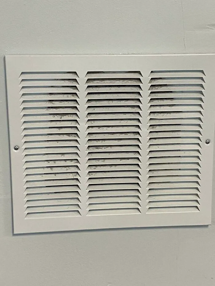 Somebody At The Gym Threw A Medicine Ball Into The Drywall. They Fixed It By Putting A Vent Grate Over It