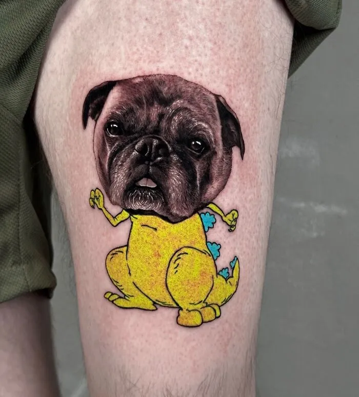 Tattoo combining a pug's realistic face with a cartoon dinosaur body, showcasing seamless artistic styles.