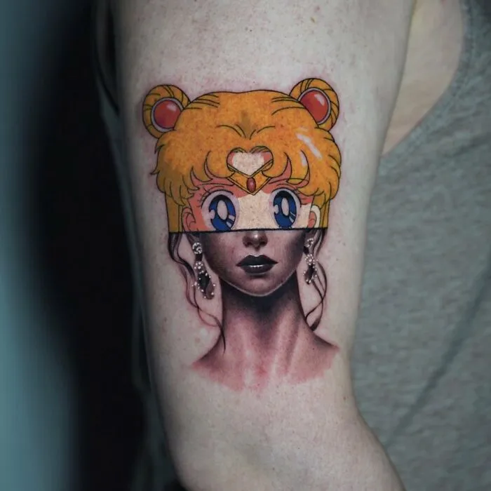 Tattoo merging anime and realism, depicting a character with colorful hair atop a monochrome portrait style.