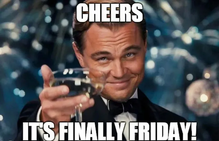 Man raising a glass with text "Cheers, it's finally Friday" celebrating happy Friday memes.