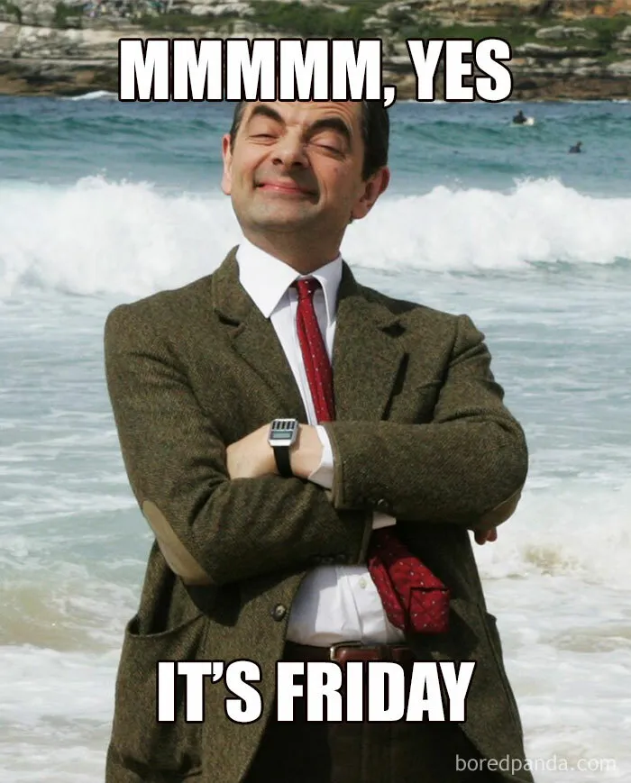 Mr. Bean enjoying the beach with a satisfied expression, captioned "Mmmm, yes it's Friday" - happy Friday meme.