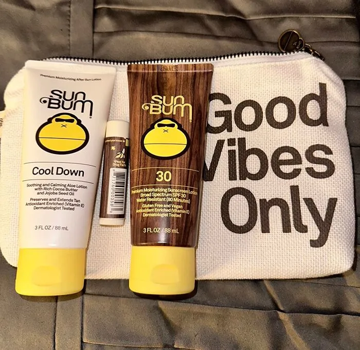 Sun Bum skincare products on a bag with "Good Vibes Only" text.